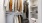 a closet with clothes and shelving