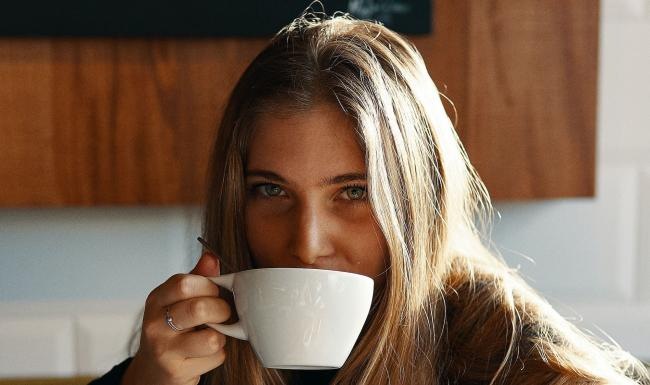 a person drinking from a cup