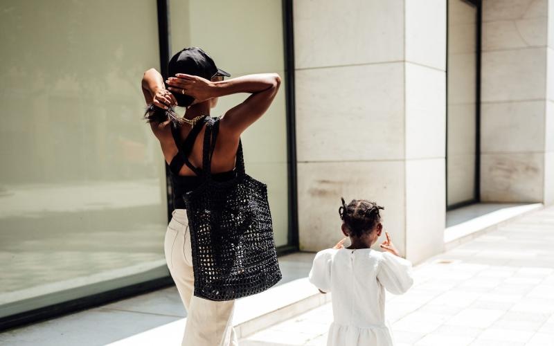 a woman walking with her child