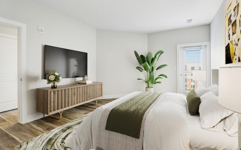 a bedroom with a bed and a plant